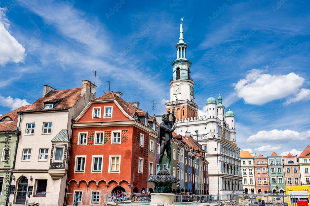 Apollo Fountain on an Old Market (Stary Rynek) square with small colorful houses and old Town Hall in Poznan, Poland