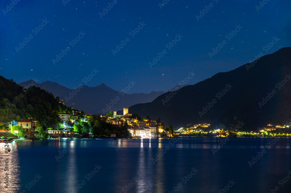 The village of Santa Maria Rezzonico, on Lake Como, photographed on a summer evening, with its tower and the Alps in the background.