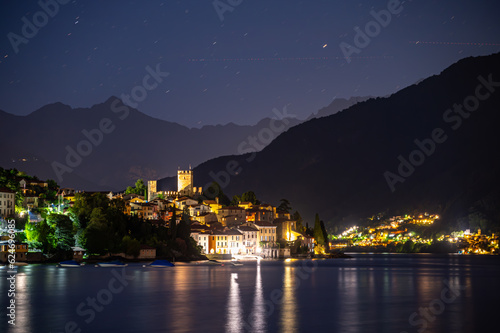 The village of Santa Maria Rezzonico, on Lake Como, photographed on a summer evening, with its tower and the Alps in the background. photo