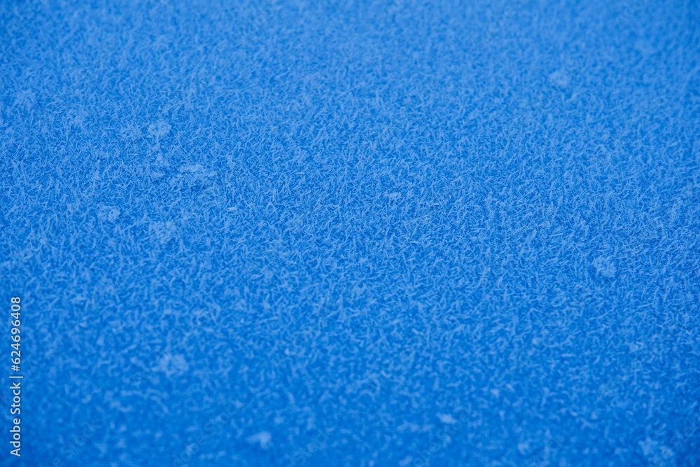 frost on blue metal,texture of frost on a blue sheet of metal, with a shallow depth of field