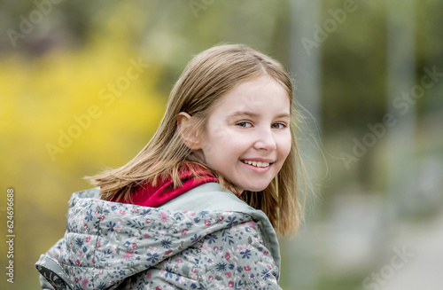 Portrait of cute little girl in autumn park