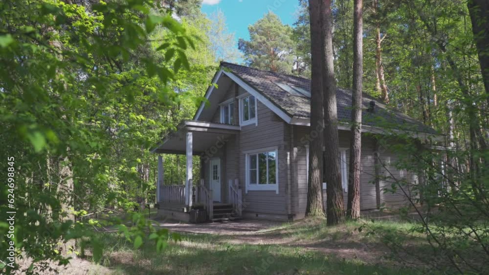 Classic country house in the Norwegian style of wood in the forest in the summer in the pines Classic country house in the Norwegian style of wood in the forest in the summer in the pines
