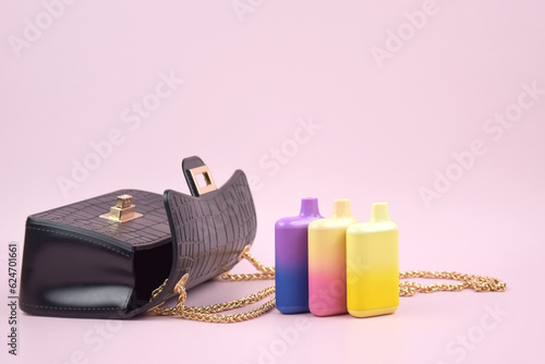 Photography Set of multicolor disposable electronic cigarettes on a pink background
