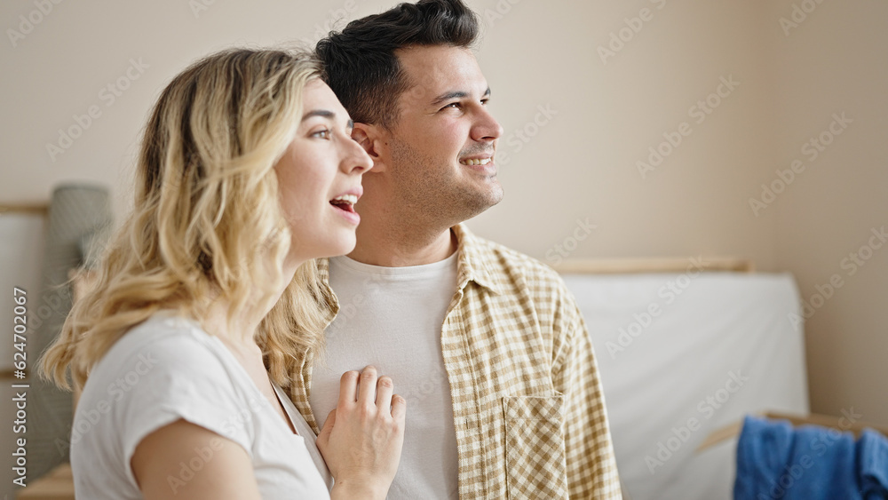 Man and woman couple hugging each other speaking at new home Man and woman couple hugging each other speaking at new home