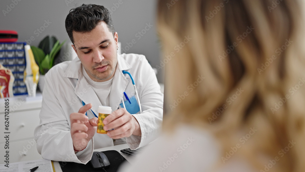 Man and woman doctor and patient prescribing pills treatment at clinic Man and woman doctor and patient prescribing pills treatment at clinic