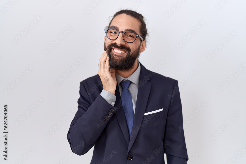 Hispanic man with beard wearing suit and tie touching mouth with hand with painful expression because of toothache or dental illness on teeth. dentist Hispanic man with beard wearing suit and tie touching mouth with hand with painful expression because of toothache or dental illness on teeth. dentist