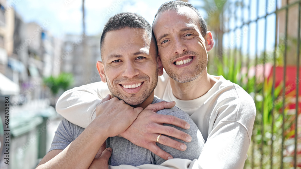 Two men couple smiling confident hugging each other at street Two men couple smiling confident hugging each other at street