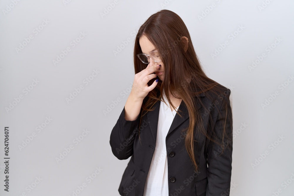 Beautiful brunette woman wearing business jacket and glasses tired rubbing nose and eyes feeling fatigue and headache. stress and frustration concept. Beautiful brunette woman wearing business jacket and glasses tired rubbing nose and eyes feeling fatigue and headache. stress and frustration concept.