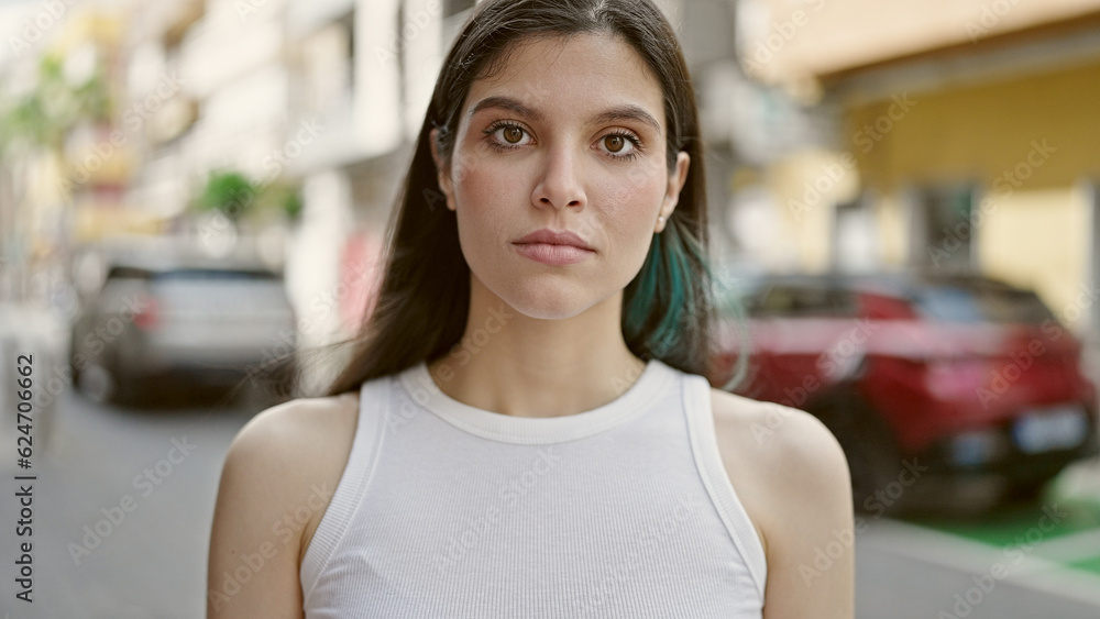 Young beautiful hispanic woman standing with serious expression at street Young beautiful hispanic woman standing with serious expression at street
