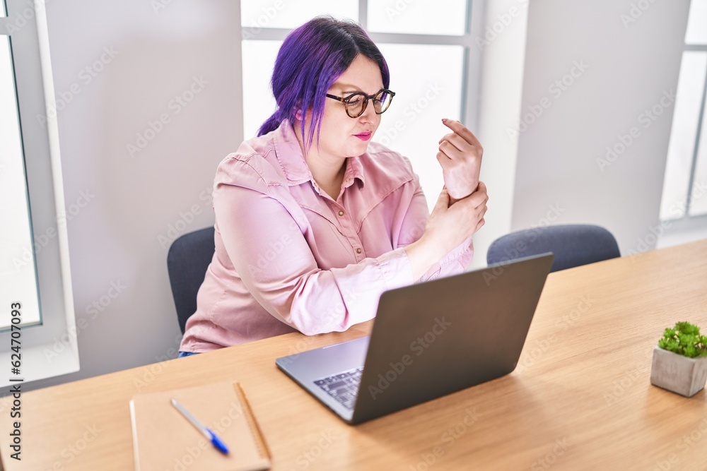 Young beautiful plus size woman business worker suffering for wrist pain working at office Young beautiful plus size woman business worker suffering for wrist pain working at office