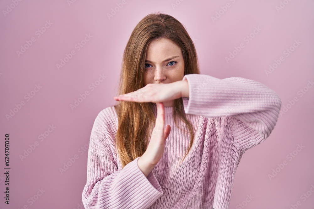Young caucasian woman standing over pink background doing time out gesture with hands, frustrated and serious face Young caucasian woman standing over pink background doing time out gesture with hands, frustrated and serious face