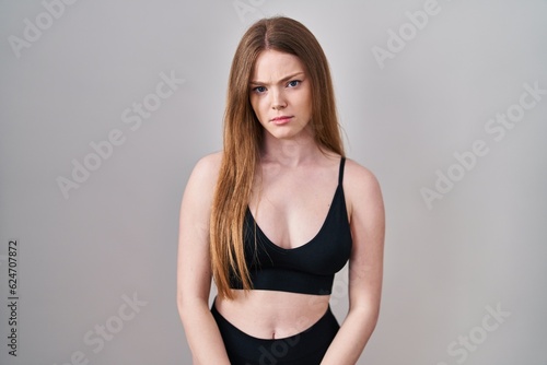 Young caucasian woman wearing lingerie skeptic and nervous  frowning upset because of problem. negative person.