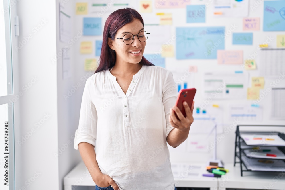 Young beautiful hispanic woman business worker smiling confident using smartphone at office Young beautiful hispanic woman business worker smiling confident using smartphone at office
