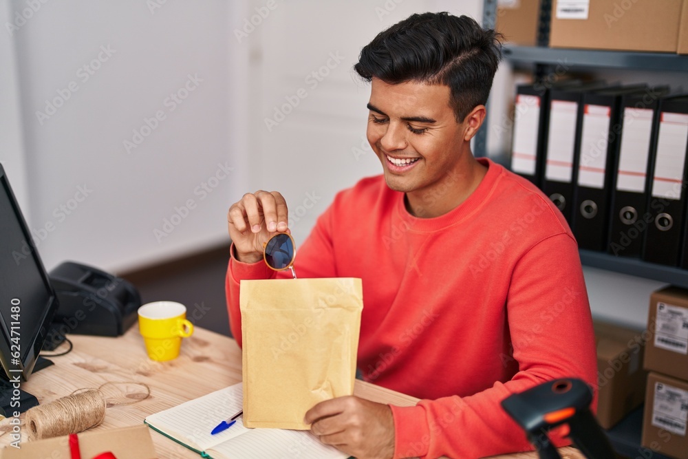 Young hispanic man ecommerce business worker prepare sunglasses package at office Young hispanic man ecommerce business worker prepare sunglasses package at office