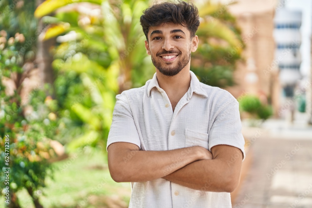 Young arab man smiling confident standing with arms crossed gesture at park Young arab man smiling confident standing with arms crossed gesture at park