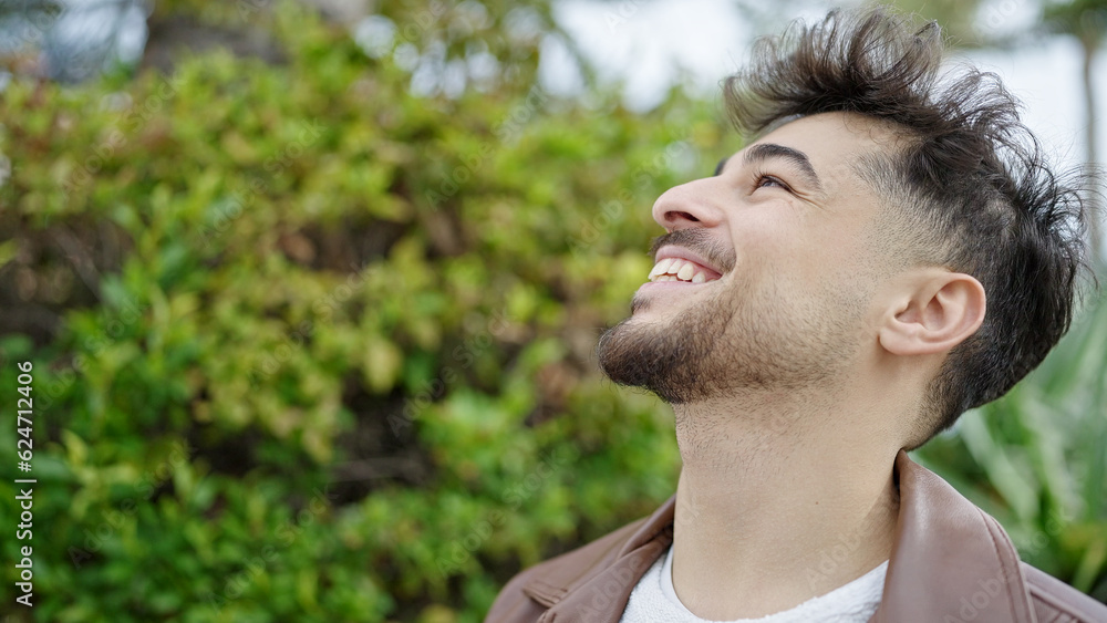 Young arab man smiling confident looking to the sky at park Young arab man smiling confident looking to the sky at park