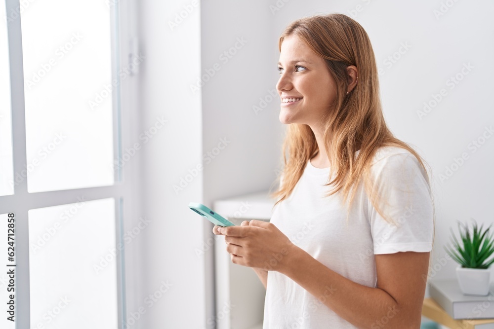 Young blonde girl smiling confident using smartphone at home Young blonde girl smiling confident using smartphone at home