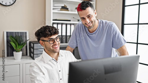 Two men business workers using computer working at office