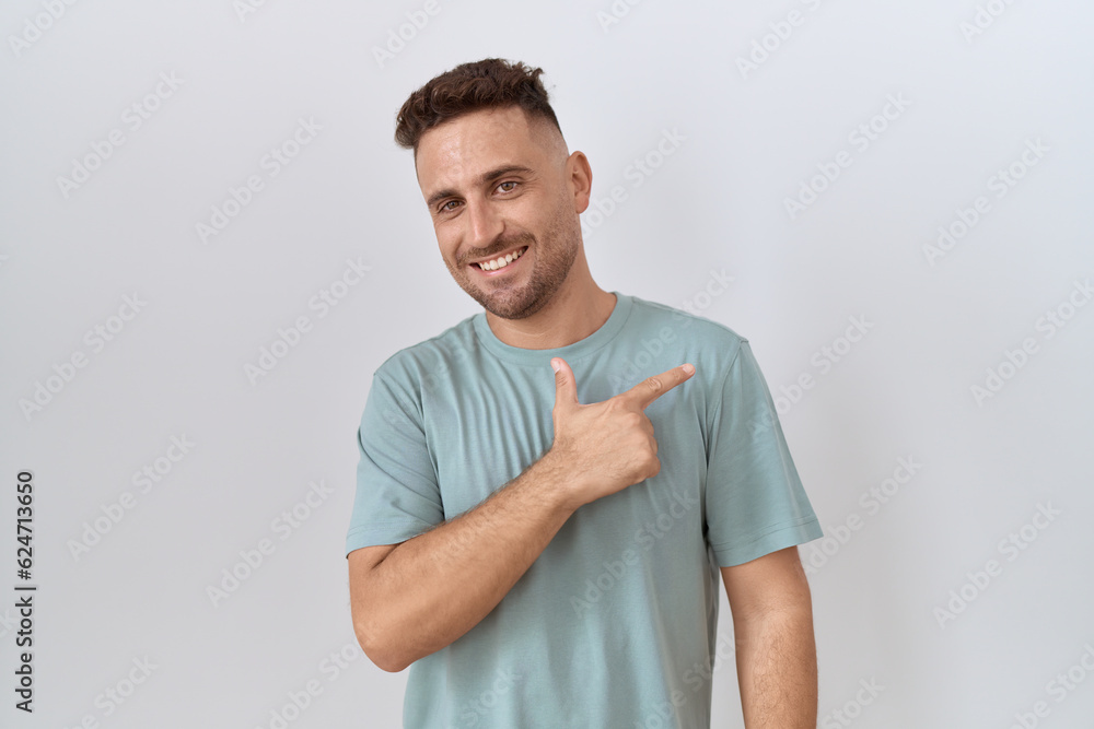 Hispanic man with beard standing over white background cheerful with a smile on face pointing with hand and finger up to the side with happy and natural expression Hispanic man with beard standing over white background cheerful with a smile on face pointing with hand and finger up to the side with happy and natural expression