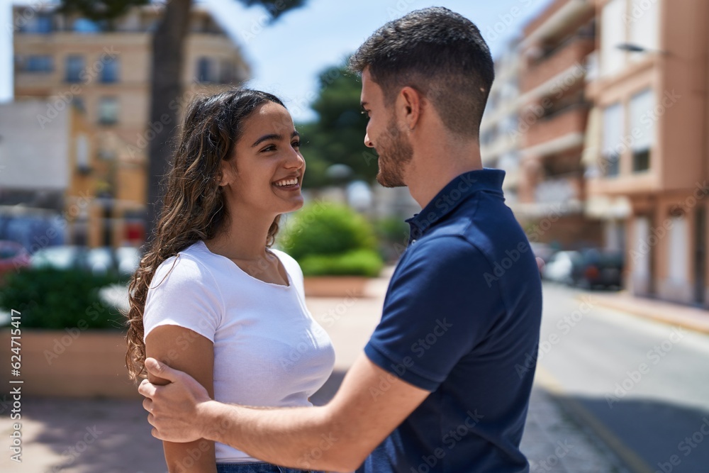 Young hispanic couple smiling confident hugging each other at street Young hispanic couple smiling confident hugging each other at street