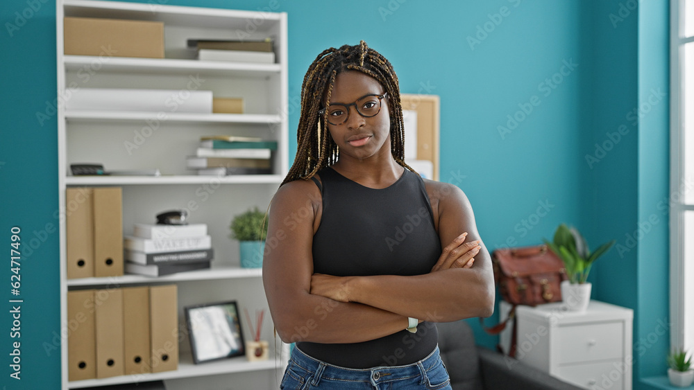 African american woman business worker standing with arms crossed gesture and serious face at the office African american woman business worker standing with arms crossed gesture and serious face at the office