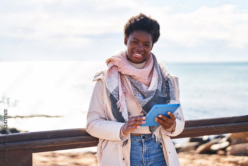 African american woman using touchpad standing at seaside African american woman using touchpad standing at seaside