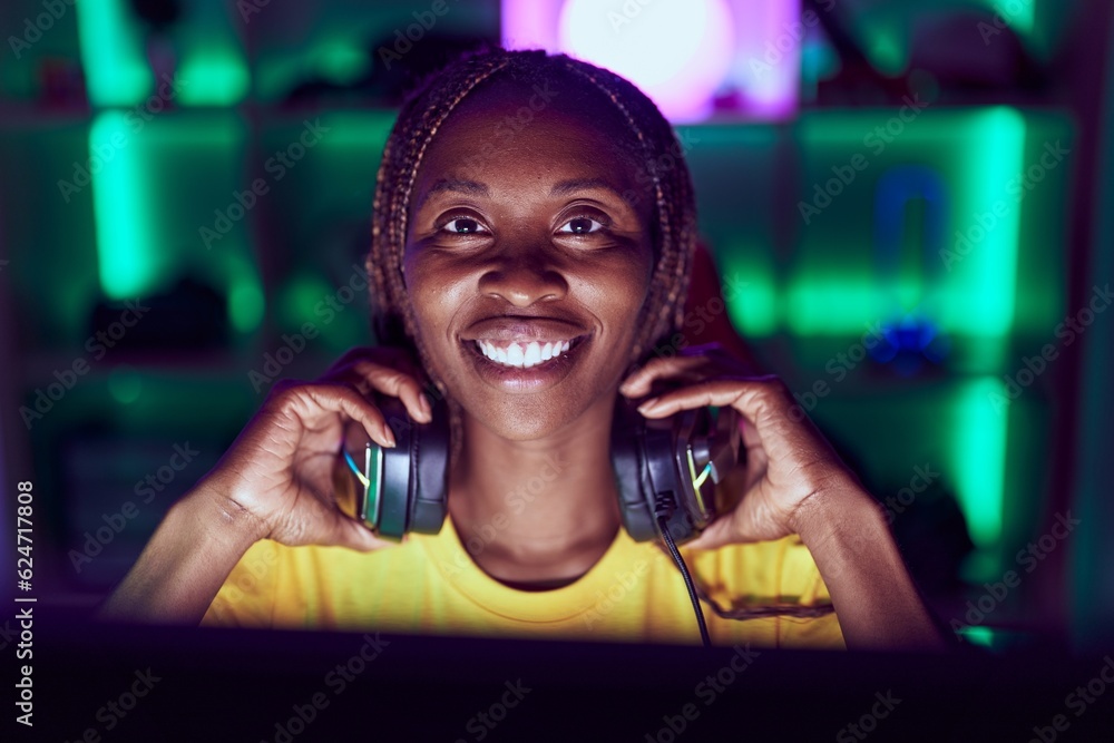 African american woman streamer smiling confident sitting on table at gaming room African american woman streamer smiling confident sitting on table at gaming room