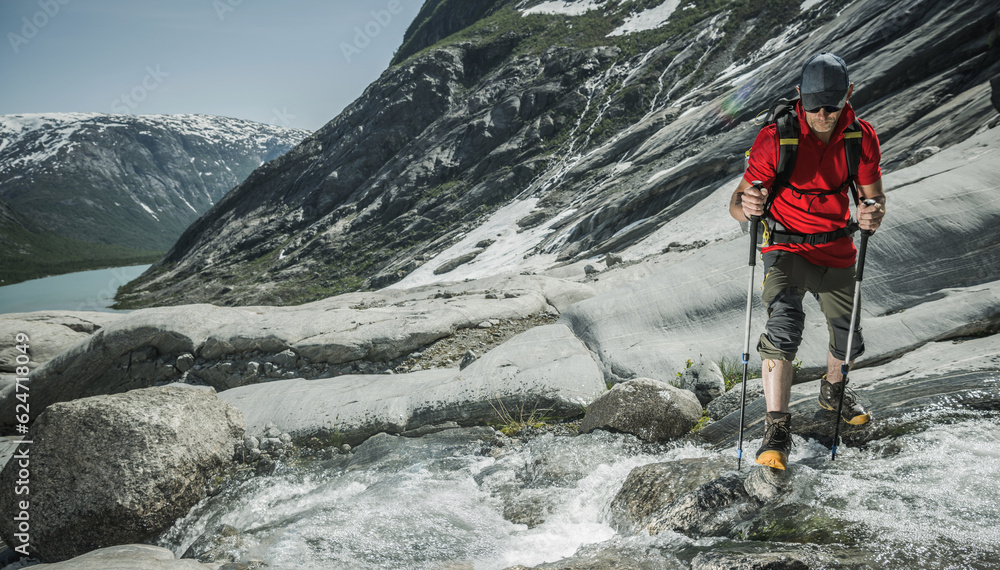Caucasian Hiker with Backpack on a Scenic Norwegian Glacier Trail