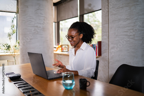 Black businesswoman working on laptop. Portrait of beautiful businesswoman in the office.
