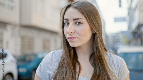 Young beautiful hispanic woman standing with relaxed expression at street
