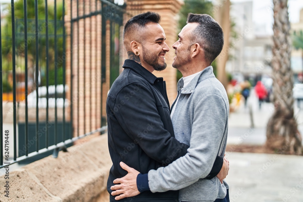 Two men couple smiling confident hugging each other at street Two men couple smiling confident hugging each other at street