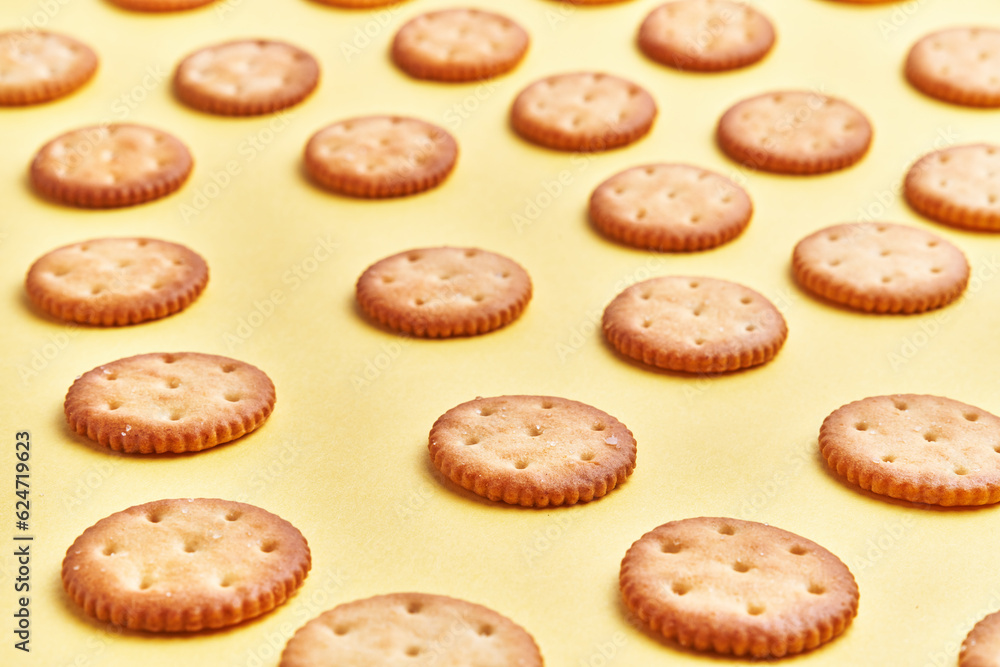 Delicious group of salty biscuits over isolated yellow background Delicious group of salty biscuits over isolated yellow background