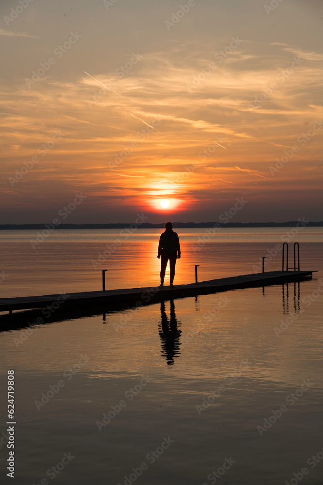 a beautiful red and orange sunset at a lake in Germany