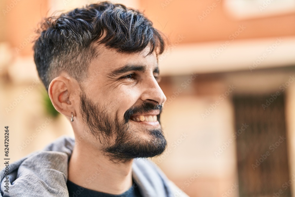 Young hispanic man smiling confident looking to the side at street Young hispanic man smiling confident looking to the side at street