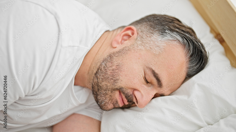 Grey-haired man lying on bed sleeping at bedroom Grey-haired man lying on bed sleeping at bedroom