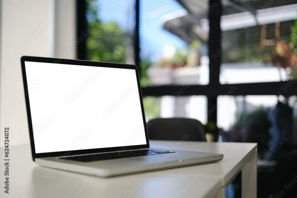 Closeup laptop computer with white empty screen on office desk. Blank screen for your advertising text message Closeup laptop computer with white empty screen on office desk. Blank screen for your advertising text message
