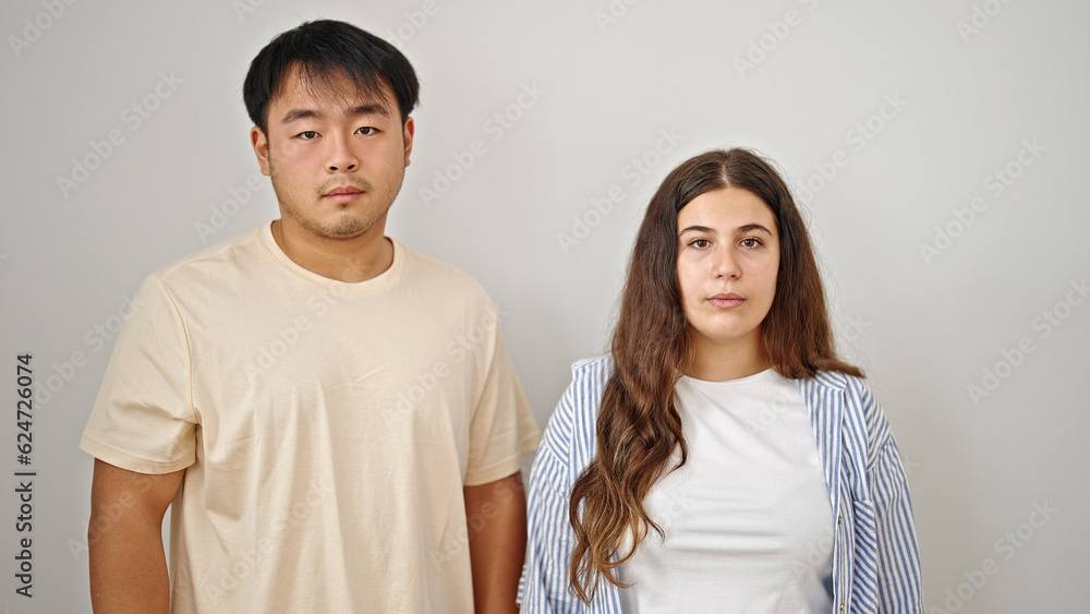 Man and woman couple standing together with serious expression over isolated white background Man and woman couple standing together with serious expression over isolated white background