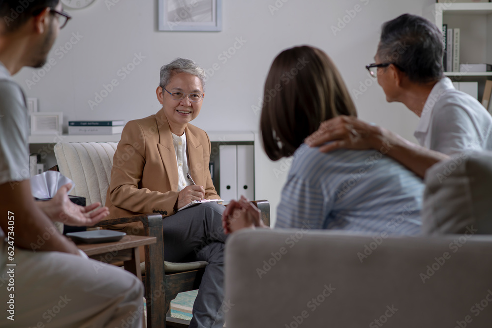 Therapist, psychologist talking and counselling to people in group therapy. Therapist, psychologist talking and counselling to people in group therapy.