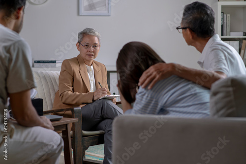 Therapist, psychologist talking and counselling to people in group therapy.