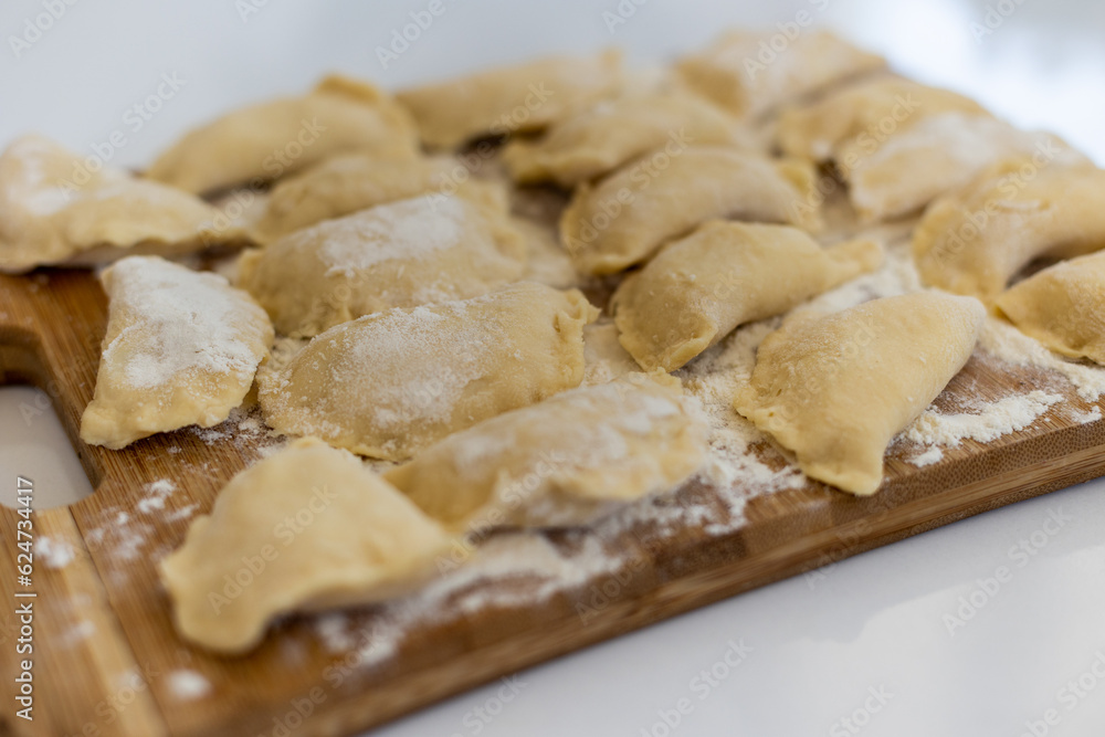 Raw dumpling. Preparation dumplings on a wooden board. Raw dumpling. Preparation dumplings on a wooden board.