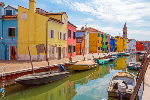 Beautiful view of the canals of Burano with boats and beautiful, colorful buildings. Burano village is famous for its colorful houses. Venice, Italy. © johnkruger1