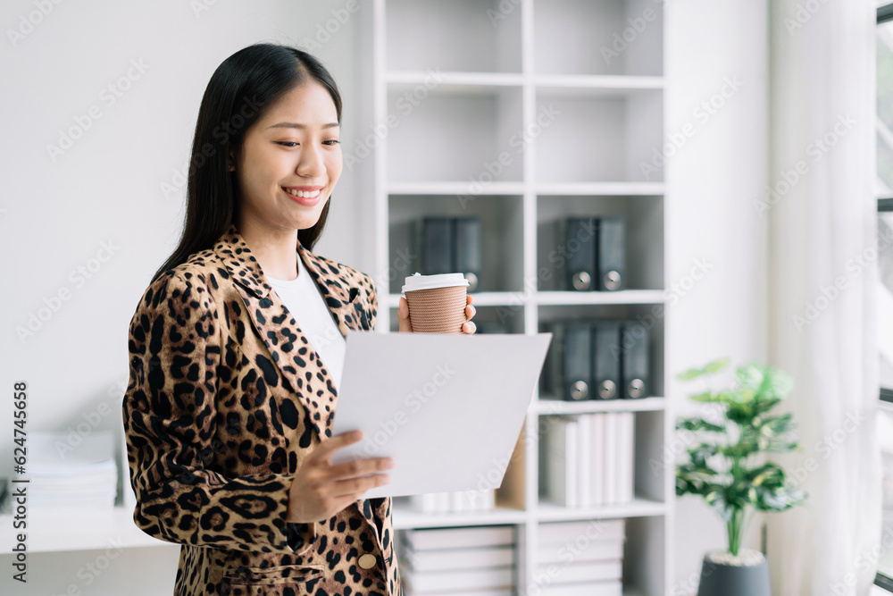 Businesswoman using a tablet and charts to analysis graph company financial in office. Businesswoman using a tablet and charts to analysis graph company financial in office.