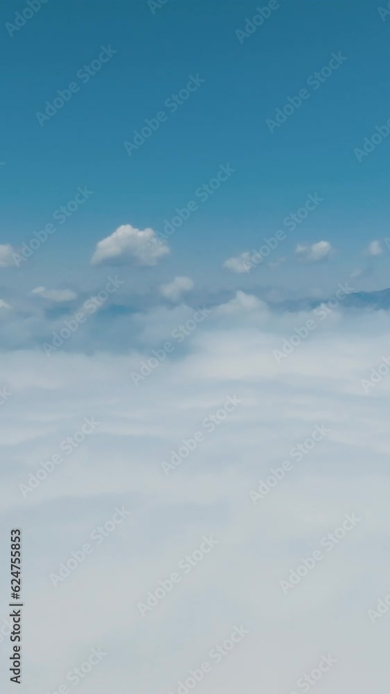 View of clouds over the mountains. Clouds over the mountains. Aerial vertical background, vertical video background, vertical video. 