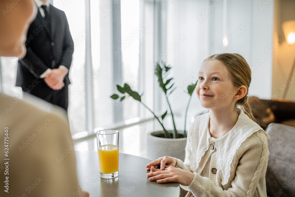 happy preteen girl talking to mother near bodyguard on blurred background, security service, private safety concept, glass of orange juice, personal safety, rich lifestyle, happy preteen girl talking to mother near bodyguard on blurred background, security service, private safety concept, glass of orange juice, personal safety, rich lifestyle,