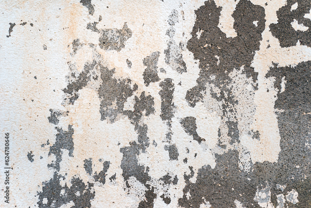 Peeled and cracked white paint on an old concrete wall. Abstract textured background. Peeled and cracked white paint on an old concrete wall. Abstract textured background.
