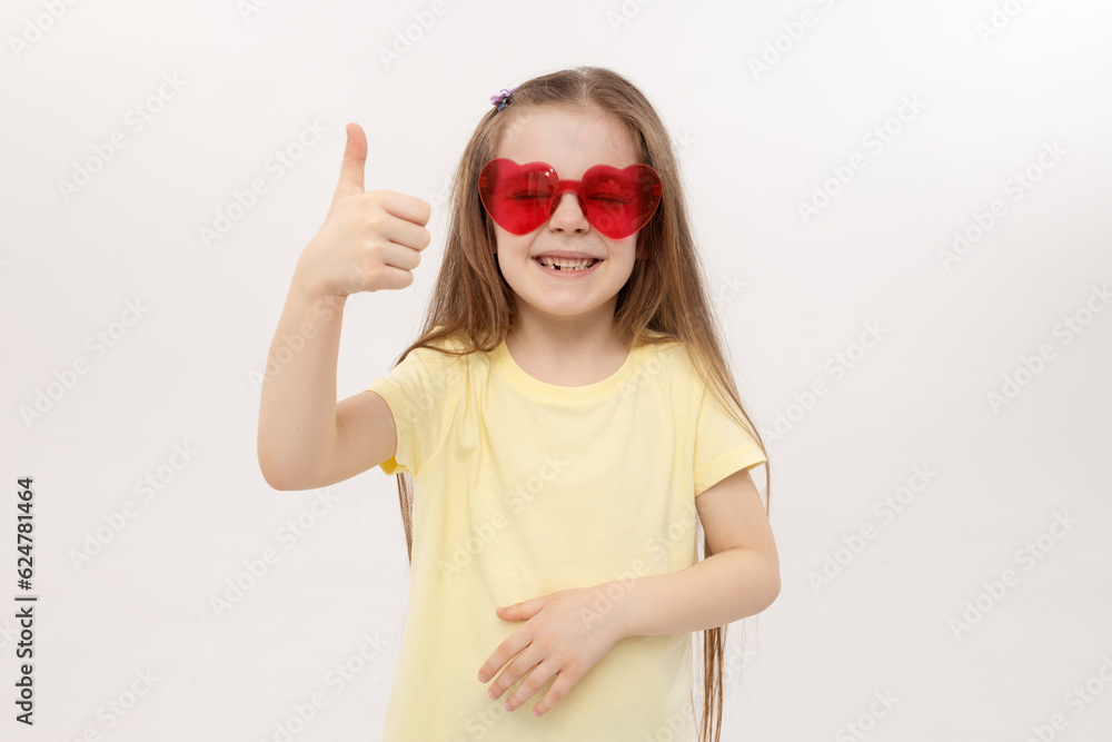 Portrait of surprised cute little toddler girl in the heart shape sunglasses. Child with open mouth having fun isolated over white background. Looking at camera. Wow funny face Portrait of surprised cute little toddler girl in the heart shape sunglasses. Child with open mouth having fun isolated over white background. Looking at camera. Wow funny face
