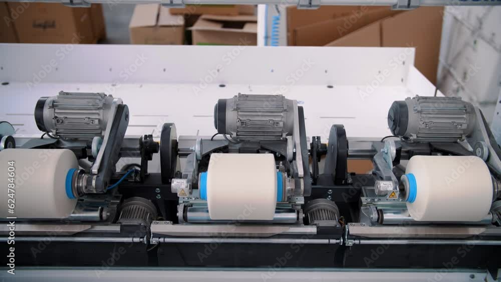 Spinning spools in the textile factory unit. Spinning production. Textile factory. Yarn making processes. Threads production. Textile factory equipment. Spinning spools in the textile factory unit. Spinning production. Textile factory. Yarn making processes. Threads production. Textile factory equipment.
