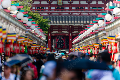 Tourists and locals crowd into Nakamise Dori Street and the Sensoji temple in Tokyo, Japan photo
