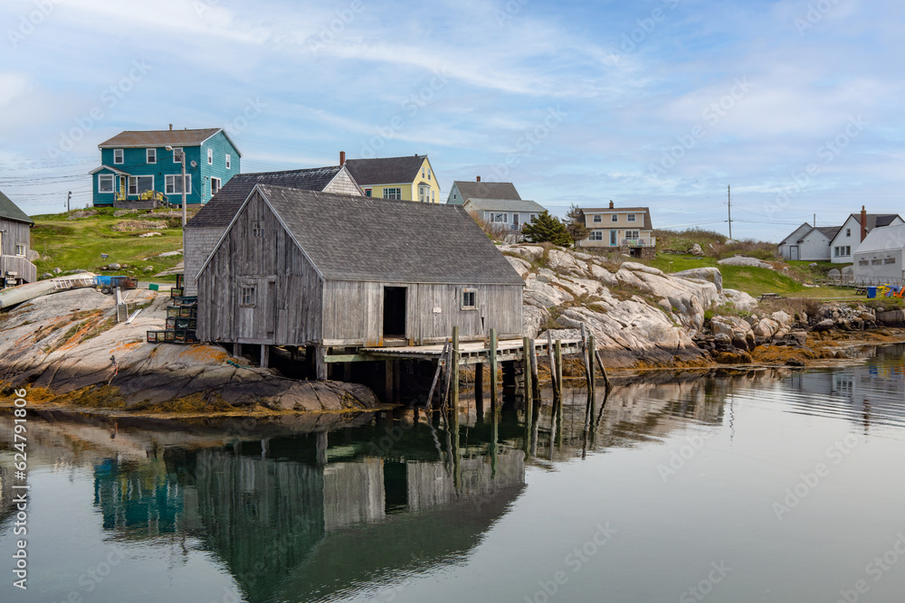 Weathered boathouse with dock in a small village on a cove on the shores of the Atlantic ocean.
