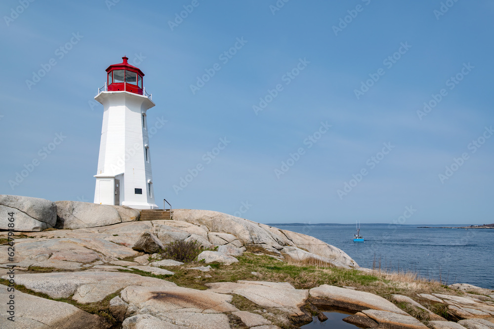 Lighthouse on the rocky shore of the Atlantic ocean coast in Nova Scotia, Canada.